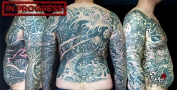 Thirtysecond sitting Biomech and oriental tattoo jacket, metal parts, cherry flowers and waves all over the sleeves, back and torso. Jerry Magni Tattoo Artist Bergamo, Milan, Italy