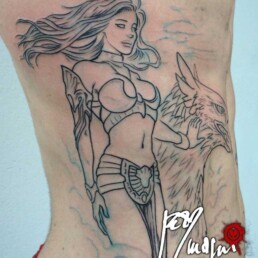 First sitting Tattoo on ribs with the mythological goddess Era, Zeus’ Wife. She’s caressing a griffin at her side, we are high and we see the clouds below. She’s beautiful and sexy. Artwork masterfully done by the best tattoo artist Jerry Magni, Bergamo, Milan, Lugano, Italy.