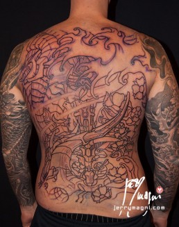 Eighteenth sitting Black and grey biomech tattoo mixed with oriental elements, cherry flowers and waves, on a back and two full sleeves. Jerry Magni Tattoo Artist Milano. Bergamo, Lugano.