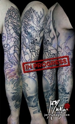 first sitting Black and grey Japanese style full sleeve tattoo with skulls, cherry flowers, waves and a big dragon that takes half of the sleeve. done by the best tattoo artist Jerry Magni, Bergamo, Milan, Lugano, Italy.