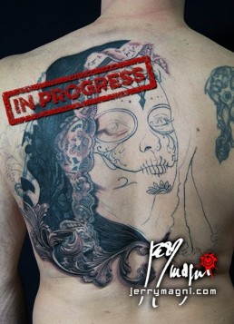 Second sitting Black and grey Back piece tattoo. Portrait of a beautiful girl with the typical make up from the Mexican day of the dead, on her head a black lace veil, behind her a couple of roses, everything surrounded by filigree. Outstanding piece of art, masterfully done by by the best tattoo artist Jerry Magni, Bergamo, Milan, Lugano, Italy.