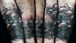 Second sitting Black and grey full sleeve tattoo. A graveyard covered with skull from which rises a majestic olive tree. in the foreground there are a few tombstone. the artwork is completed by clouds at the horizon, above them a full moon on which there are clock arms pointing five minutes to midnight. Outstanding piece of art, masterfully done by by the best tattoo artist Jerry Magni, Bergamo, Milan, Lugano, Italy.