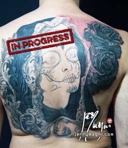 Fourth sitting Black and grey Back piece tattoo. Portrait of a beautiful girl with the typical make up from the Mexican day of the dead, on her head a black lace veil, behind her a couple of roses, everything surrounded by filigree. Outstanding piece of art, masterfully done by by the best tattoo artist Jerry Magni, Bergamo, Milan, Lugano, Italy.