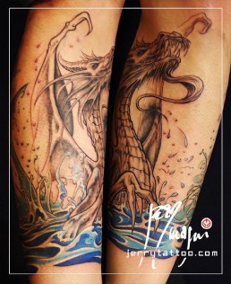 Second sitting Full colour tattoo with a sexy blue tail mermaid on a rock, in front of her a blue winged dragon rises from the water, Under the sea surface we see corals. Masterfully executed by the best tattoo artist Jerry Magni, Bergamo, Italy, Milano, Italy, Lugano.
