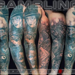 Black and grey full sleeve tatto with a lot of elements, on the forearm a Joker, palying cards, dice, eight ball, and a container for cinematographic film. Inside the arm a Duesenberg car and the city lights. On the arm a clock and on the shoulder a woman with a top hat and a monocle. Beautifully done by the best tattoo artist, Jerry Magni, Italy, Lombady, Milan, Bergamo, Lugano.