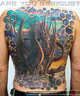 back piece colour tattoo with a enormous dragon on top of a mountain at the sunset and a small knight confronting him. Masterfully done by Jerry Magni one of the best Italian tatto artist.