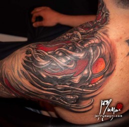 Seventh sitting Biomech bio organic full sleeve and part of the neck tattoo. Abstract shapes with scales and stings in which there are a human blue eye and a snake eye. The background is done with orange, purple and red color. Done by by the best tattoo artist Jerry Magni, Bergamo, Milan, Lugano, Italy.