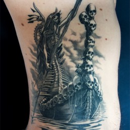 Black and grey gothic tattoo on ribs. Horror, skulls, mythology, ancient gods, divine comedy. Jerry Magni Tattoo Artist Italy