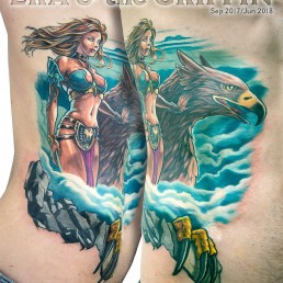 Tattoo on ribs with the mythological goddess Era, Zeus’ Wife. She’s caressing a griffin at her side, we are high and we see the clouds below. She’s beautiful and sexy. Artwork masterfully done by the best tattoo artist Jerry Magni, Bergamo, Milan, Lugano, Italy.