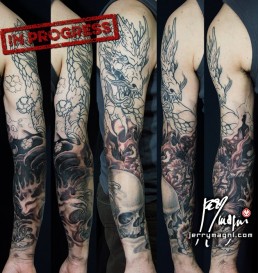 Third sittin Black and grey Japanese style full sleeve tattoo with skulls, cherry flowers, waves and a big dragon that takes half of the sleeve. done by the best tattoo artist Jerry Magni, Bergamo, Milan, Lugano, Italy.