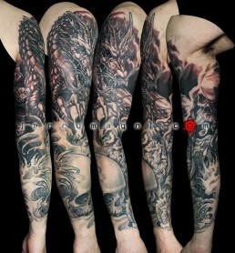 Fourth sitting Black and grey Japanese style full sleeve tattoo with skulls, cherry flowers, waves and a big dragon that takes half of the sleeve. done by the best tattoo artist Jerry Magni, Bergamo, Milan, Lugano, Italy.