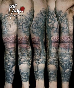 Sevent sitting Black and grey full sleeve tattoo. A graveyard covered with skull from which rises a majestic olive tree. in the foreground there are a few tombstone. the artwork is completed by clouds at the horizon, above them a full moon on which there are clock arms pointing five minutes to midnight. Outstanding piece of art, masterfully done by by the best tattoo artist Jerry Magni, Bergamo, Milan, Lugano, Italy.