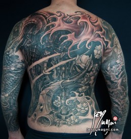 Twentysecond sitting Black and grey biomech tattoo mixed with oriental elements, cherry flowers and waves, on a back and two full sleeves. Jerry Magni Tattoo Artist Milano. Bergamo, Lugano.