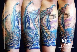 Third sitting Full colour tattoo with a sexy blue tail mermaid on a rock, in front of her a blue winged dragon rises from the water, Under the sea surface we see corals. Masterfully executed by the best tattoo artist Jerry Magni, Bergamo, Italy, Milano, Italy, Lugano.